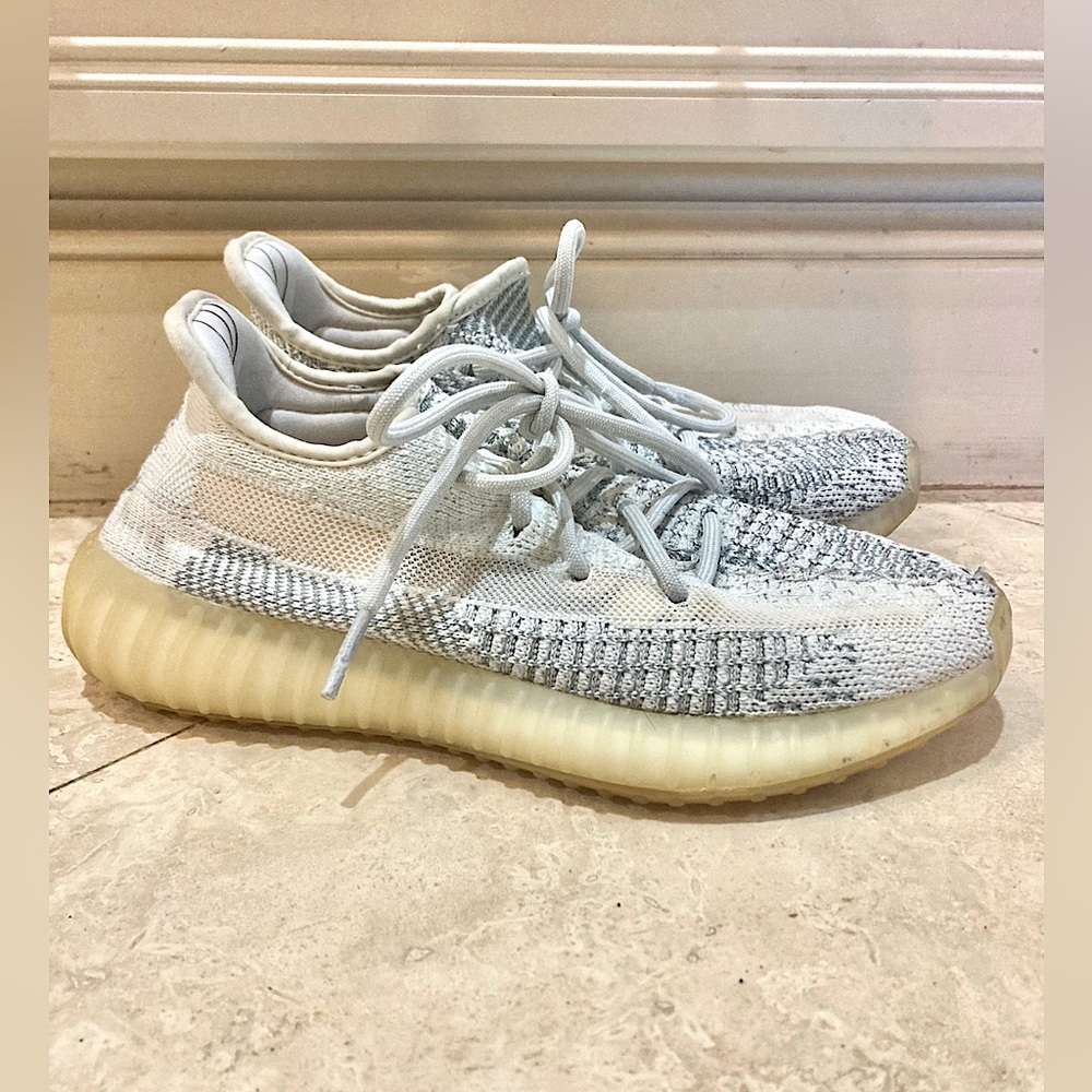 White/cream colored Yeezy sneakers